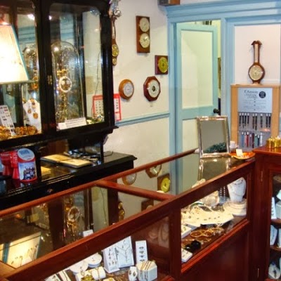 I'Anson Jewellers & Goldsmiths Inside the shop, the slate-blue interior and the clock wall.