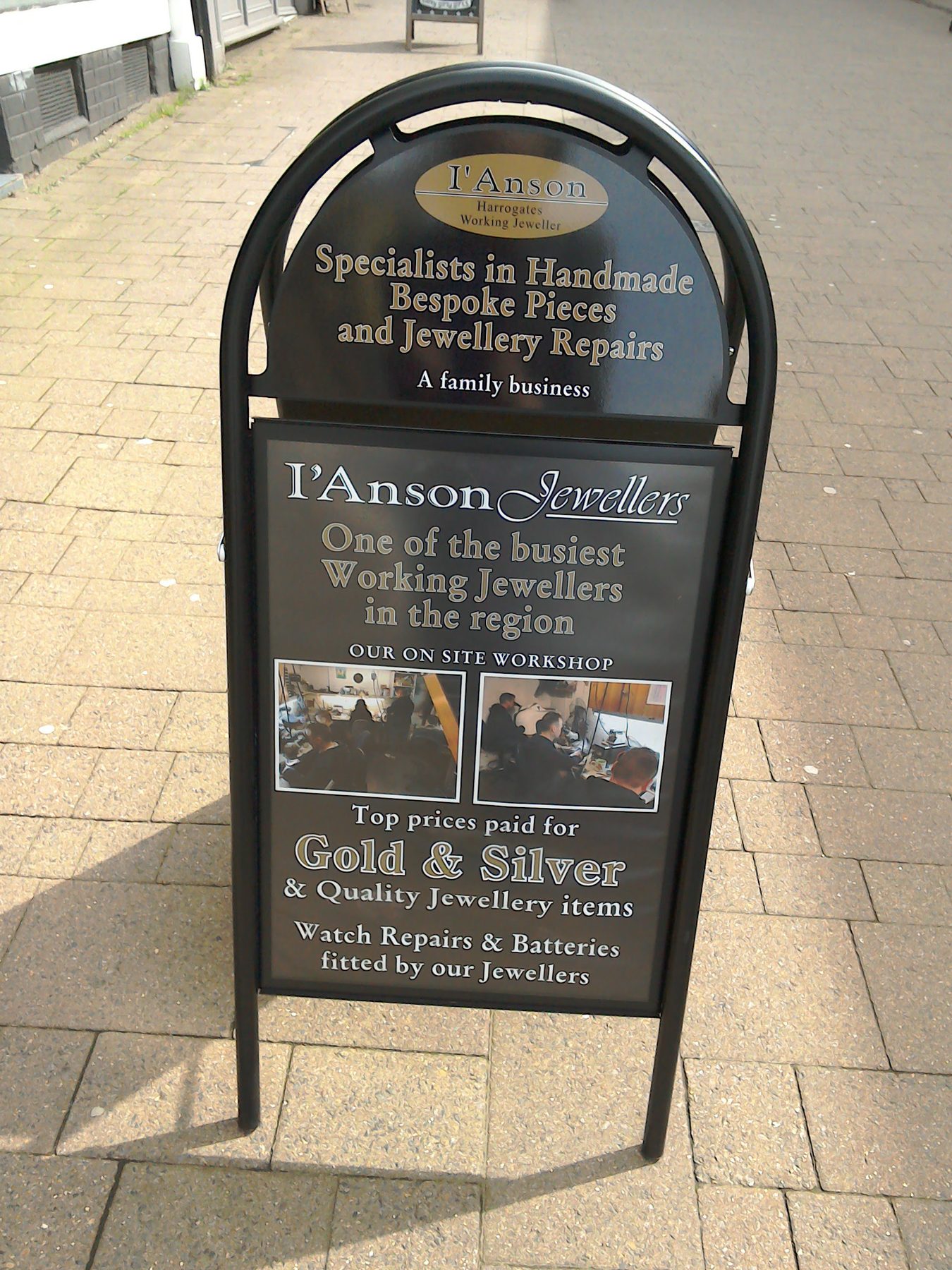 The shopfront of I'Anson Jewellers at 40 Beulah Street, Harrogate, with the black awning and the gilt l'Anson sign